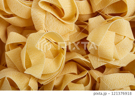 raw pappardelle pasta, pasta nests, in a paper box, top view, no people, 121376918
