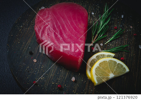fresh red tuna fillet, for steak, raw, top view, on a cutting board, no people, 121376920