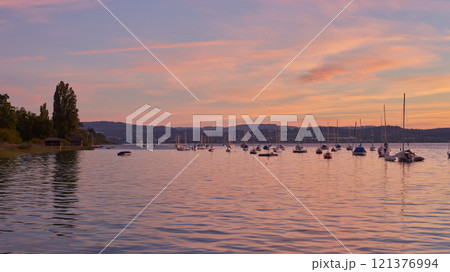 Sunset Overlooking Lake Bodensee in Germany. Bodensee Lake Sunset Panorama. Evening Sunlight Over Tranquil Waters. Sunset Vista at Lake Bodensee in Germany. 121376994