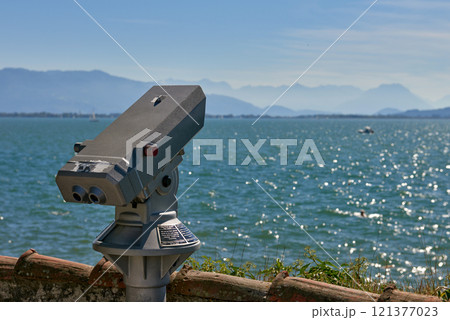 Panoramic Binocular Overlooking Bodensee Sailboats and Swiss Alps from Lindau, Germany. Scenic Summer View Captures European Vacation Paradise with Yacht Racing and Mountain Vistas. 121377023