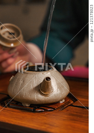 Artisan Ceramics Teapot Pouring Tea in a Beautiful and Traditional Cultural Setting 121378023