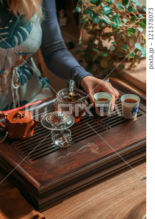 The Traditional Tea Ceremony Featuring an Elegant Table Setting Along with Beautiful Accessories The Traditional Tea Ceremony Featuring an Elegant Table Setting Along with Beautiful Accessories 121378073