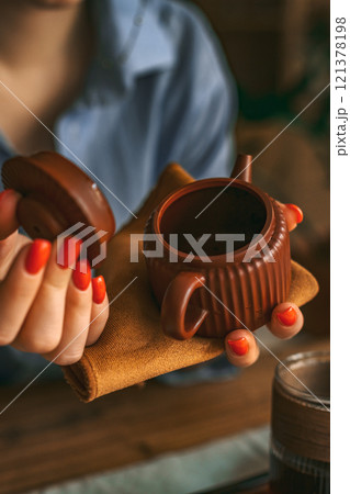 A Sophisticated Teapot with Cozy Styling in Warm Tones enhances any dining experience 121378198