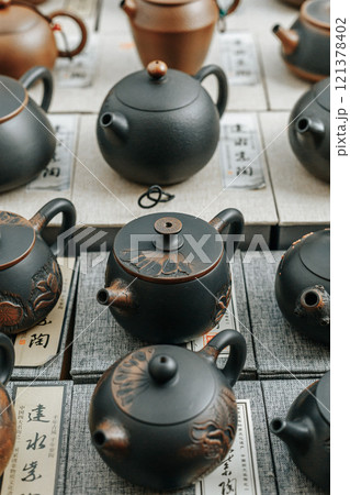 A Beautiful Display of Traditional Teapots in a Stunning and Artistic Arrangement 121378402