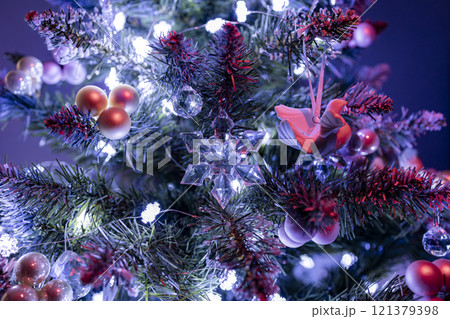 A simple and elegant Christmas tree decorated with white lights and a few delicate ornaments. Perfect for creating a minimalist and modern holiday atmosphere. A simple and elegant Christmas tree decorated with white lights and a few delicate ornaments. Perfect for creating a minimalist and modern holiday atmosphere. 121379398