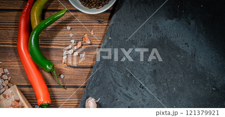 rustic steak cutting board with rosemary and spices , dark rustic wooden background, top view, place for text 121379921