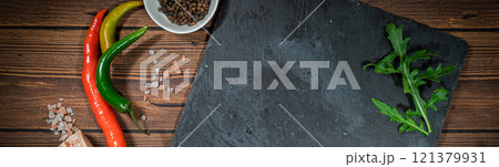 rustic cutting board with rosemary and spices , dark rustic wooden background, top view, place for text rustic cutting board with rosemary and spices , dark rustic wooden background, top view, place for text 121379931