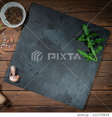 rustic cutting board with rosemary and spices , dark rustic wooden background, top view, place for text rustic cutting board with rosemary and spices , dark rustic wooden background, top view, place for text 121379934