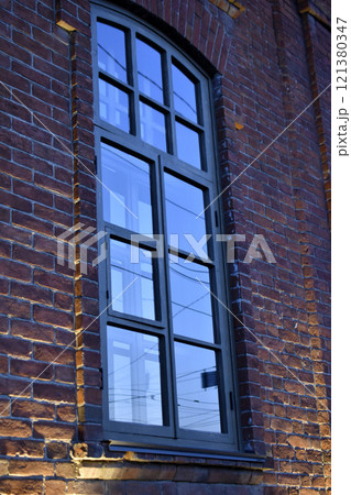 Classic windows in a brick house. Beautiful black windows in the house. Classic windows in a brick house. Beautiful black windows in the house. 121380347