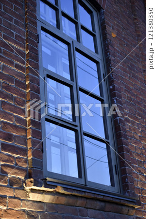 Classic windows in a brick house. Beautiful black windows in the house. Classic windows in a brick house. Beautiful black windows in the house. 121380350