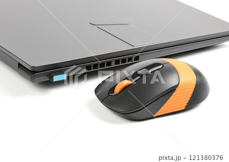 Laptop and wireless mouse on white. 121380376