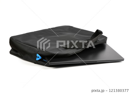 Black laptop peeks out of the bag on white background. 121380377