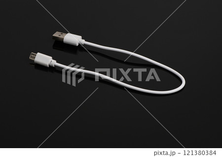 USB cable on a black background. USB cable on a black background. 121380384