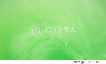 Light emulsion. Liquid paint. Defocused bright green color cloud ink mist vortex vapor steam moving on abstract art background. 121380410