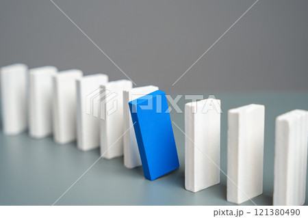 A blue domino peeks out from a row of white ones. Stand out. Initiative and talent. Unique and special 121380490