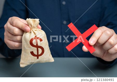 Man holding red cross and dollar money bag. Refusal to grant a loan. Failure to return the collateral. Refusal of sale and cooperation. Risk of confiscation of funds. 121380491