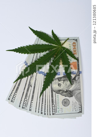 Hemp leaf and dollars on white background, closeup. Hemp leaf and dollars on white background, closeup. 121380685