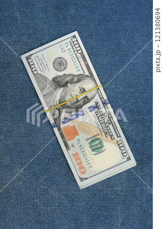 Dollars on denim background. 100 dollar pocket money. 121380694