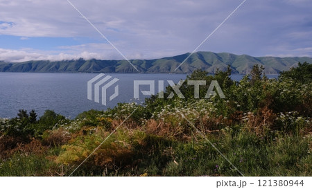 Breathtaking Scenic Coastal View Featuring Lush Green Hills and Serene Peaceful Waters 121380944