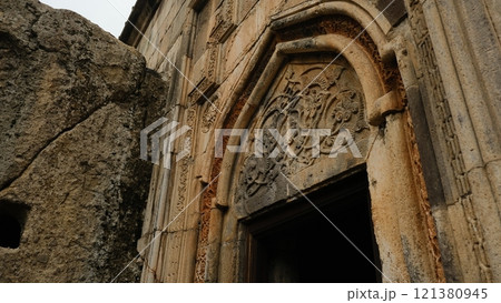 An Ancient Stone Doorway adorned with Intricate Carvings that showcases rich history and artistry 121380945