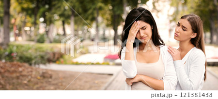 Friendship And Support. Compassionate Girl Comforting Desperate Female Friend Standing Outdoor In Park. 121381438