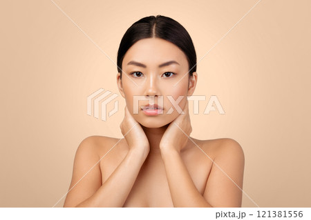 Skin And Body Care. Portrait Of Attractive Korean Woman Touching Her Neck Looking At Camera Posing Shirtless On Gray Studio Background. Natural Beauty Routine, Body And Facial Massage 121381556