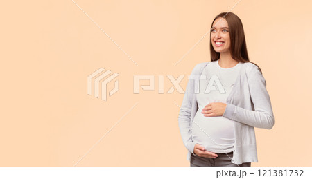Happy Pregnancy. Smiling Pregnant Woman Touching Belly Looking Aside Standing Over White Studio Background. Empty Space, Panorama 121381732