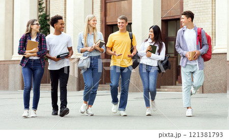 University life. Classmates walking outside and talking about passed exams University life. Classmates walking outside and talking about passed exams 121381793