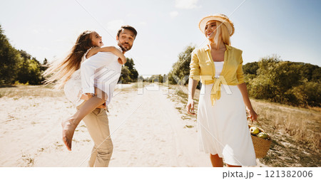 Finally, Outdoor. Family Of Three Walking Outside, Father Carrying Daughter Having Fun On Summer Day In Countryside. Finally, Outdoor. Family Of Three Walking Outside, Father Carrying Daughter Having Fun On Summer Day In Countryside. 121382006