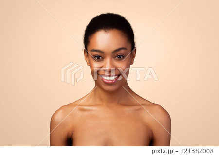 Female Beauty Portrait. Attractive African American Woman Smiling Looking At Camera Posing Shirtless Expressing Positive Emotions Over Gray Studio Background. Sensuality And Body Care Concept 121382008