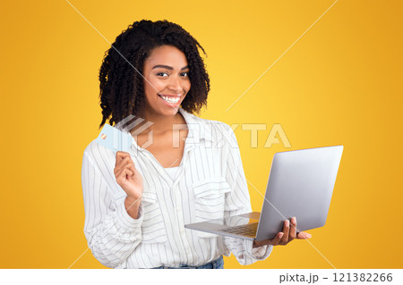 Easy Payment. Black woman holding credit card and laptop for online shopping, booking hotel or travel 121382266