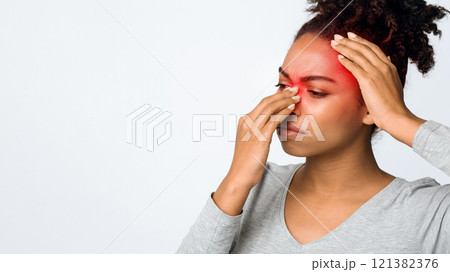 Exhausted afro woman rubbing nose and head, suffering from sinusitis, grey background, copy space 121382376