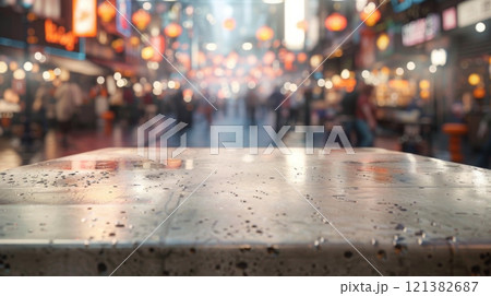 A wet countertop with a busy market street in the background. 121382687