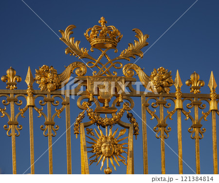 Fragment of bright golden decorative fence of palace ensemble in Versailles. 121384814