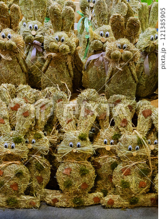 Easter decorative bunnies made from hay stand in rows, ready for sale. Handmade. Easter decorative bunnies made from hay stand in rows, ready for sale. Handmade. 121385905