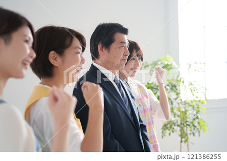 保育園の保育士たち複数人と園長先生(ガッツポーズ) 保育園の保育士たち複数人と園長先生(ガッツポーズ) 121386255