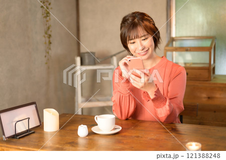 カフェでスマホを使う女性　 121388248