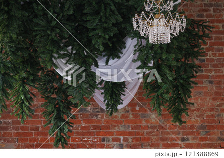 Christmas tree with a chandelier on the ceiling. Creative Christmas decor. Christmas tree with a chandelier on the ceiling. Creative Christmas decor. 121388869