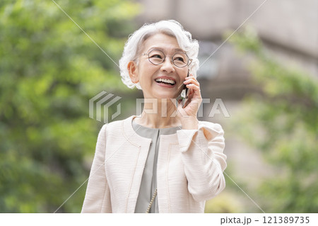 スマートフォンで通話する笑顔のシニア女性 121389735