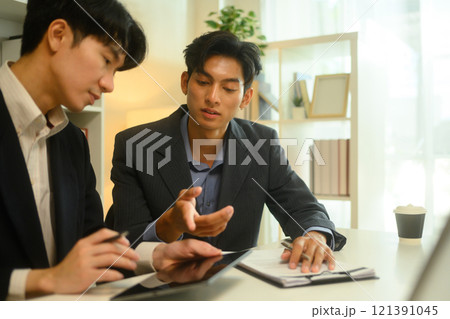 Professional lawyer in formalwear discussing contract terms with client during at office Professional lawyer in formalwear discussing contract terms with client during at office 121391045