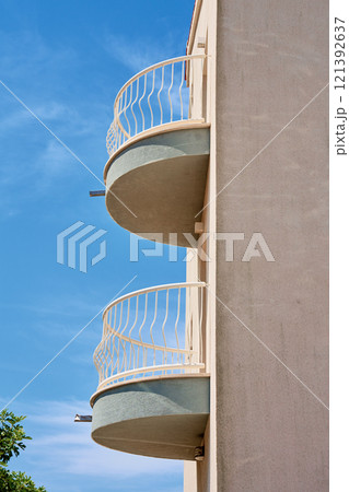 Minimalist Building with Circular Balconies Against Blue Sky 121392637