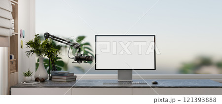 A modern, simple office workspace featuring a computer with a white desktop mockup and a microphone. A modern, simple office workspace featuring a computer with a white desktop mockup and a microphone. 121393888
