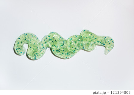 Shimmering green gel with blue glitter on white background Shimmering green gel with blue glitter on white background 121394805
