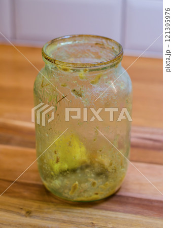 Dirty glass Jar with Leftover Food on wood table in kitchen . High quality photo 121395976