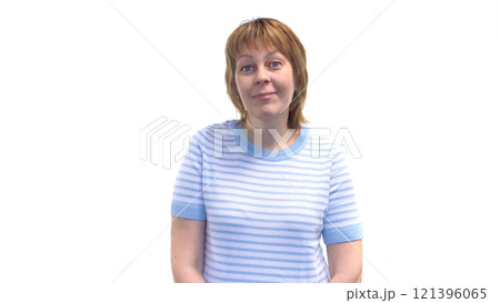 A beautiful woman smiles sweetly at the camera. Isolated on a white background. 121396065