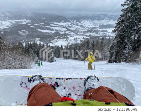 Snowboarder's View Down Mountain Slope Snowboarder's View Down Mountain Slope 121396649