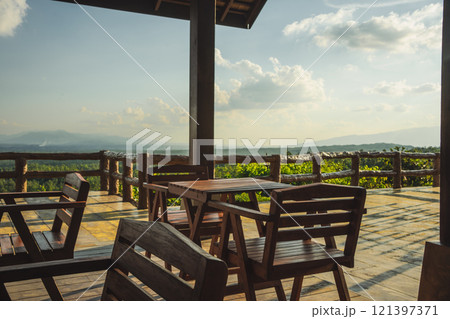 travel and people activity concept with wood chair in restaurant with mountain and tropical forest background travel and people activity concept with wood chair in restaurant with mountain and tropical forest background 121397371