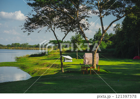 travel and people activity concept with camping on grass with mountain and lake on foreground travel and people activity concept with camping on grass with mountain and lake on foreground 121397378