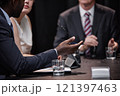 Cropped shot of African American politician negotiating with colleague chairing meeting asking man questions during political debate or press conference, copy space 121397463