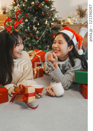 Two friends decorated Christmas tree at home. Two friends decorated Christmas tree at home. 121398267